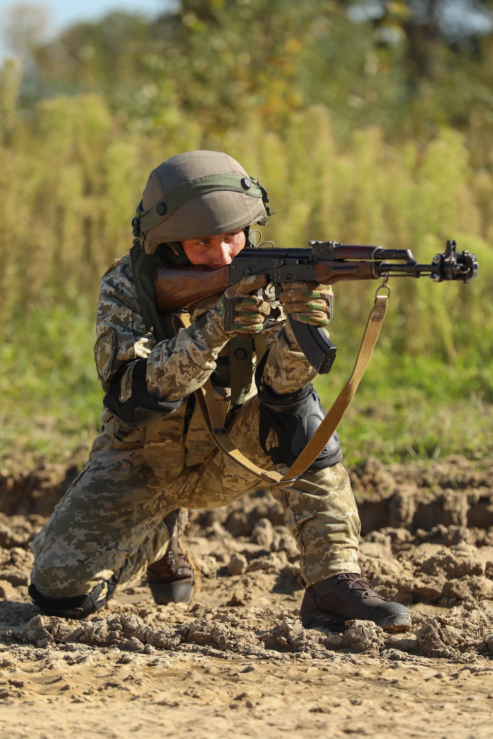 Soldier firing from a kneeling position in the field