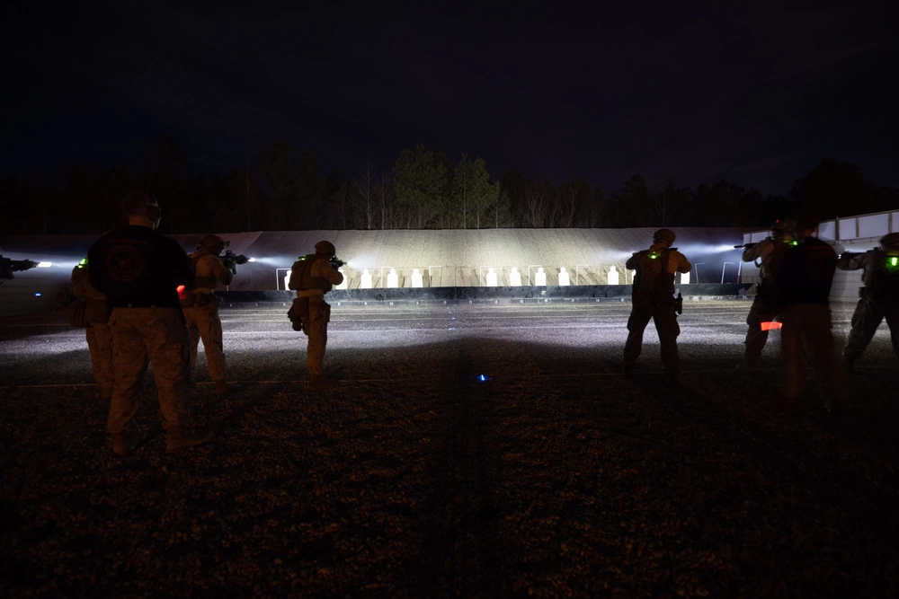 Operators training on an illuminated outdoor range at night