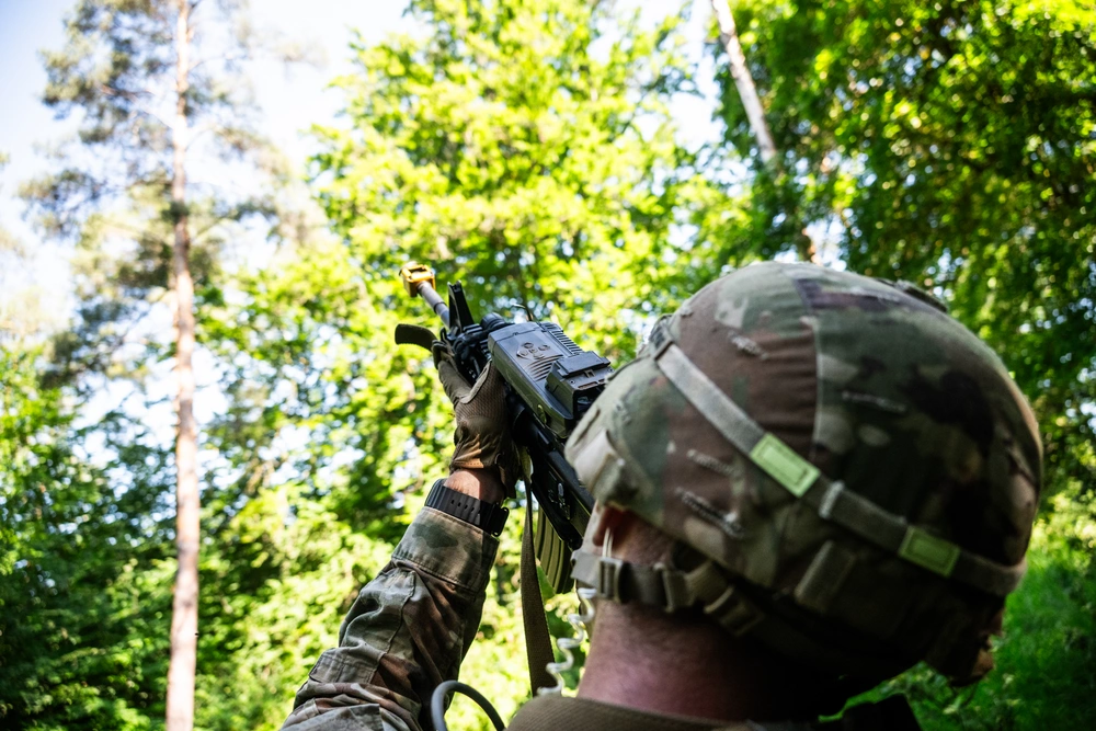 Service member aiming upward during Counter-UAS training