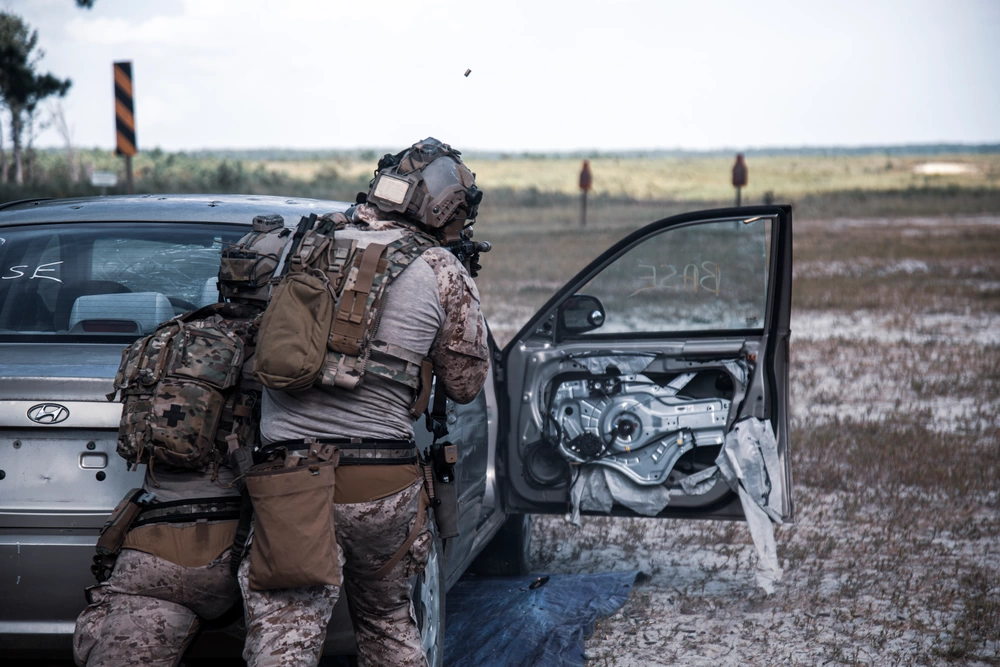Operators working beside a vehicle with its front door open